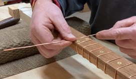 Making and Installing Copper Wire Frets on a Cigar Box Guitar.